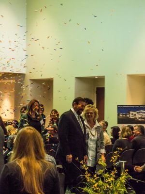 A man and a woman are surrounded by confetti