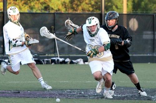 CSU players Josh Gregg (11), left, and and is Brian Roach (30) run for the ball after winning a face off at the game against Colorado University at the RMLC playoffs in Grand Junction on Friday. The Rams wom the game 8-5.