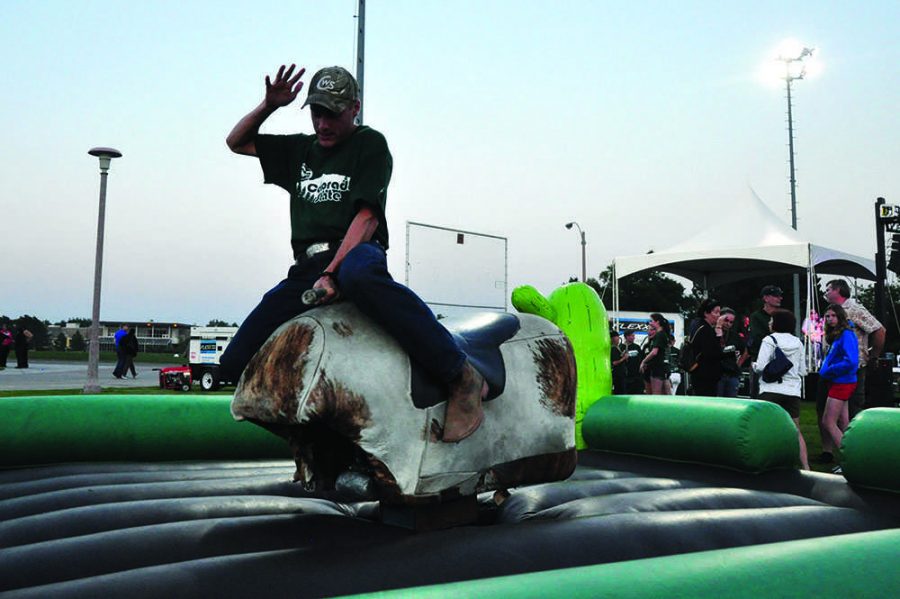 Ram Welcome 2012: A student rides a mechanical bull at the Ram Welcome Carnival, typically held midweek after all new students have moved into their dorms. 