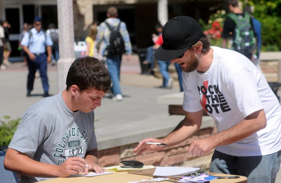 Kevin Kruglet, left, is assisted by voter registration volunteer Will Minton while filling out his Colorado voter registration form in 2010 on the Plaza outside of the Lory Student Center.
