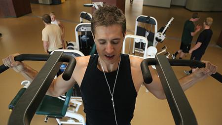 Senior journalism major Nick Henley performs a pull-up at the Campus Recreation center Tuesday afternoon.