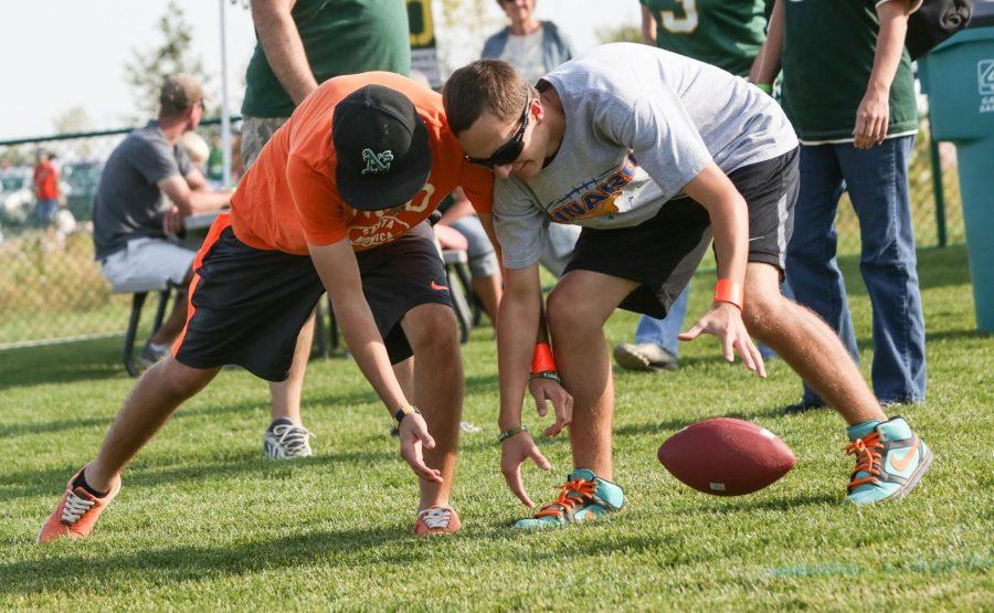 Brother Joe, left, and Adam D'antonio, both 14, fight for a loose ball while playing a game of 500 at the Ag Day celebration outside of Hughes Stadium Saturday afternoon. The annual alumni barbque gets together past and present Rams in an effort to raise scholorship money for for students.