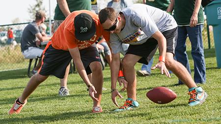 Brother Joe, left, and Adam D'antonio, both 14, fight for a loose ball while playing a game of 500 at the Ag Day celebration outside of Hughes Stadium Saturday afternoon. The annual alumni barbque gets together past and present Rams in an effort to raise scholorship money for for students.