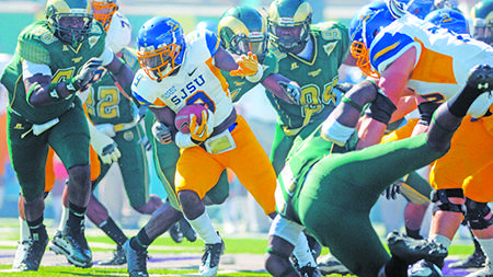 San Jose State running back Brandon Rutley (9) bursts through the CSU defense at Huges Staduim Saturday. Rutley lead San Jose State to a last minute 38-31 win over the Rams in the homecoming game.