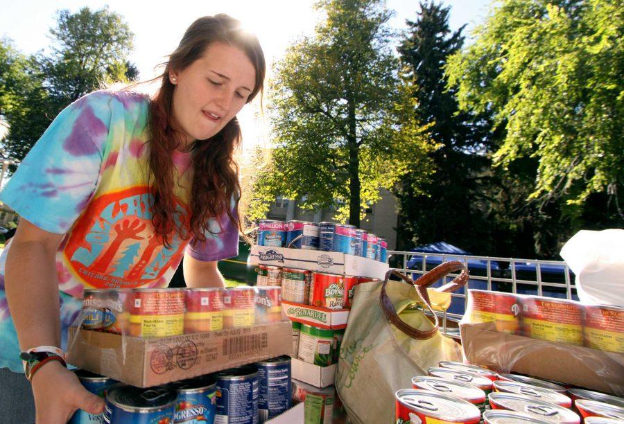 Freshman horiticulture major Charlotte Donatelli loads cans into a crate during Cans around the Oval event last year. The fundraiser is Larimer County's largest single day food drive.