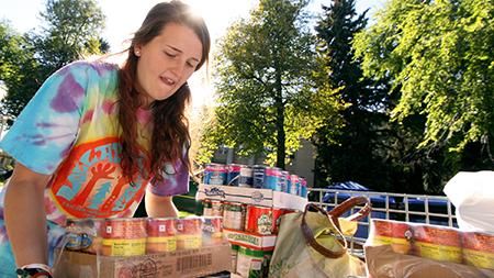 Freshman horiticulture major Charlotte Donatelli loads cans into a crate during Cans around the Oval event last year. The fundraiser is Larimer County's largest single day food drive.