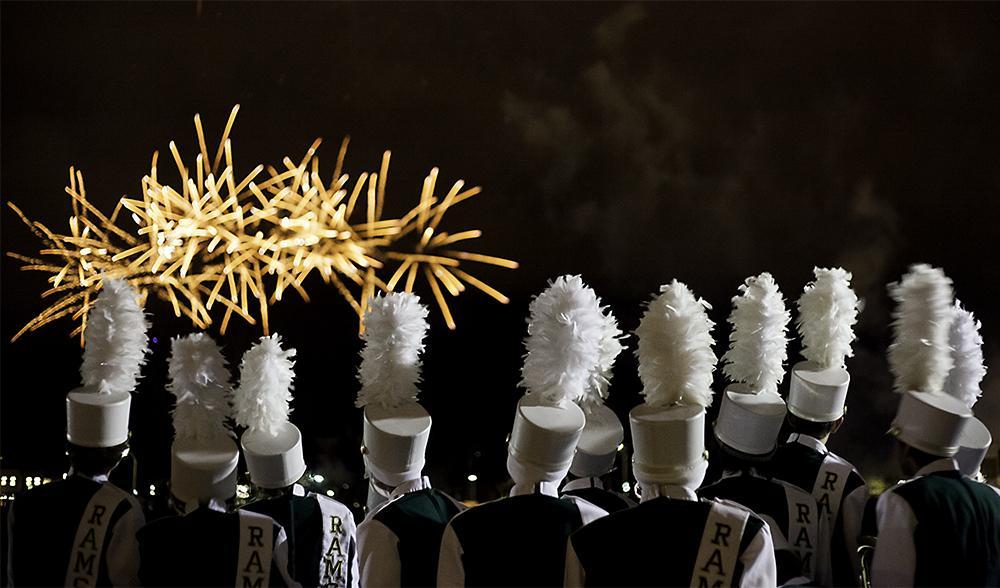 Members of the CSU marching band watch as fireworks are set off during Friday nights homecoming weekend festivities behind the Lory Student Center.