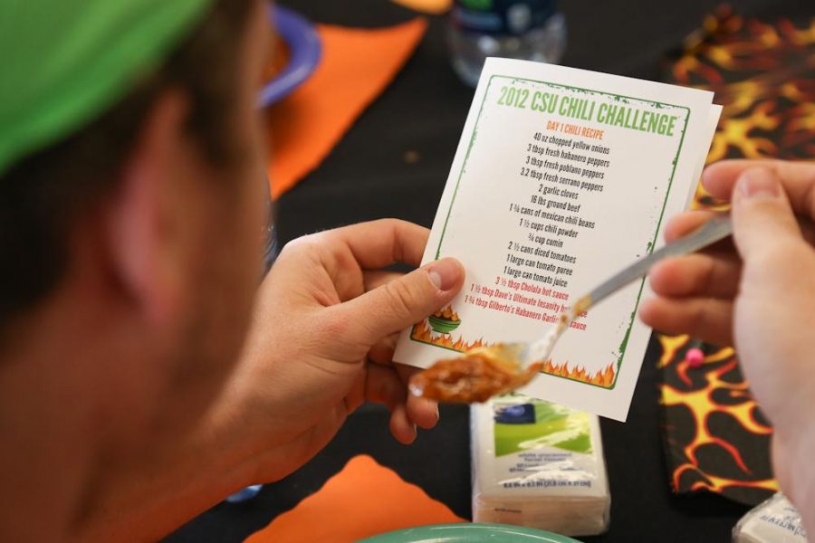 Freshman biology major Oliver Mischler reads the recipe for the first day's chili at the 2012 chilli challenge in Corbett dining hall Monday afternoon.