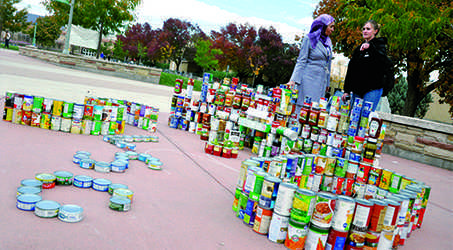 Senior student and Silver Wings member Chelsea Wight explains the can model of the student center on the plaza during the LSC-themed structure building competiton Wednesday afternoon. CANstruction is the kick off to Cans Around the Oval, an annual CSU tradition intended to raise food, money and awareness about hunger in the community.