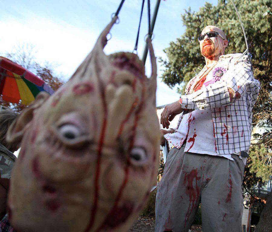 Brett roth and a disembodied head on the end of a pole get ready to enjoy a night at the Zombie Crawl in Old Town on Saturday, Oct. 20, 2012.