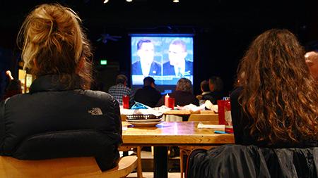 Voters look on as the two presidential candidates debate live on TV. Several watch parties were held throughout Fort Collins including this one at Avogadros Number on Monday night.