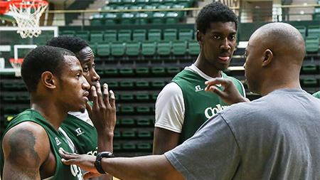 New basketball recruits from left, Jordan Mason, Jonathan Octeus and Gerson Santo recieve pointers from assistant coach Leonard Perry during a break in the team scrimmage at practice in Moby Arena Wednesday morning.