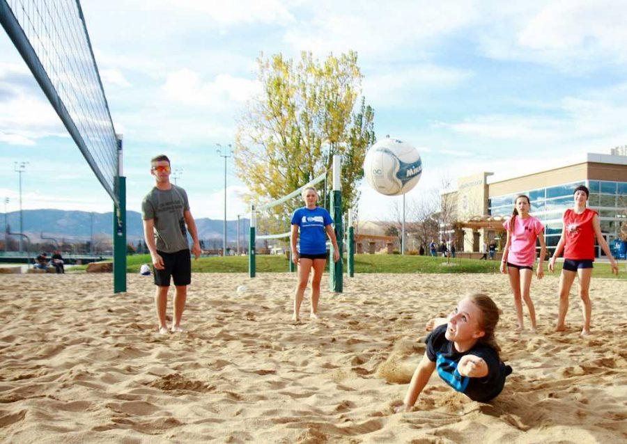 Kaylee Kirzek dives to get the ball at practice for the Loveland Volleyball Club on the courts by the Rec Center. The Sand Volleyball courts as well as the rest of the IM fields are always open for use by students when the weather permits.