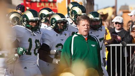 Head Coach Jim McElwain leads the team onto the field at the Wyoming game this past Saturday. The Rams will play UNLV this Saturday at 5 p.m. at Hughes Stadium.