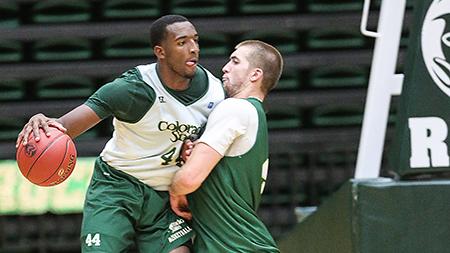 Greg Smith, 44, attempts to push past Pierce Hornung, 4, during practice. The Rams will be looking for their second straight home win against Chadron State tomorrow night at Moby Arena.