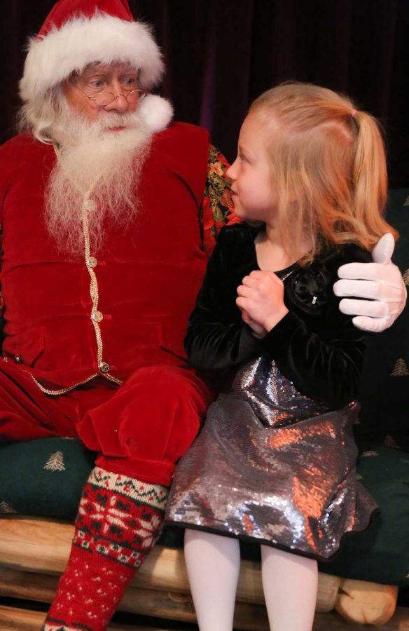 Shay Ramey, 7, tells Santa Claus what she wants for christmas at Santa's Workshop in Old Town Square Sunday afternoon. Santa's workshop is open Wednesday thru Sunday from noon to 6pm until Christmas eve.