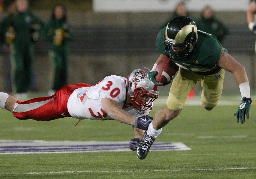 Joe Hansley, 25, is taken down by Matt Raymer, 30, of New Mexico during the third quarter of Saturday evenings win at Hughes Stadium. After fighting back and fourth all game, Colorado State prevailed over New Mexico 24-20 to finish the season with a record of 4-8.
