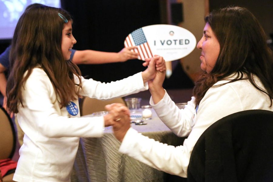 Cathy Arbaca and her daughter Elena, 8, dance after early results are given in President Obama's favor at the Colorado Democratic watch party in the Sheridan Hotel in Downtown Denver, Colo.  (Photo by Dylan Langille)