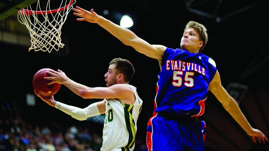 Senior guard Wes Eikmeier,10 reverses a layup past Evansville freshman center Egidijust Mockevicius,55  during the Rams 79-72 win over the visiting Purple Aces at Moby Arena Saturday afternoon. The Colorado State Rams improved to 6-0, and now have recorded 17 straight wins at home.