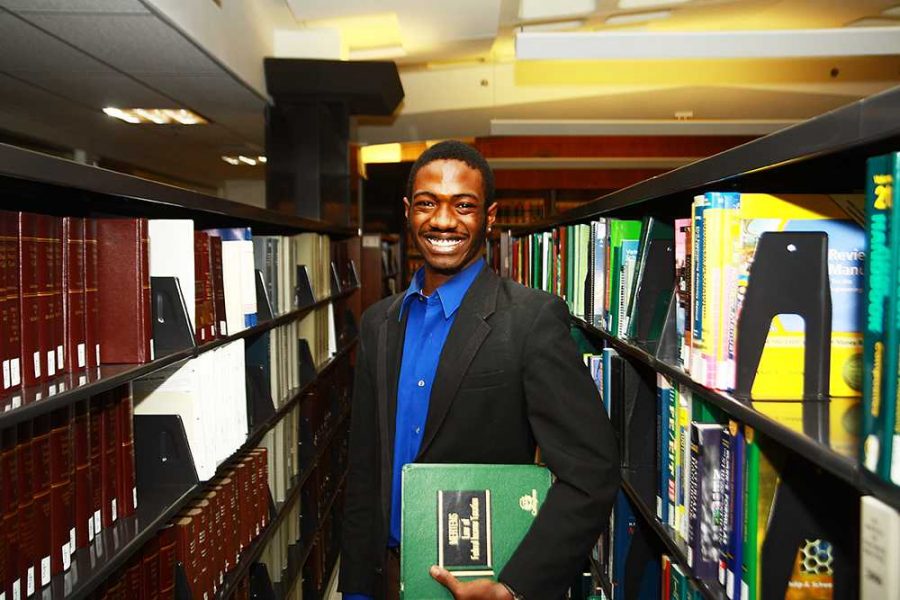 Nigel Daniels, president of the Pre-law club, stands in the law section of the library Monday afternoon. Although many law students believe there is little to no hope for getting a job in law upon graduation, Daniels still has hope as he gets ready to take the LSAT next year.