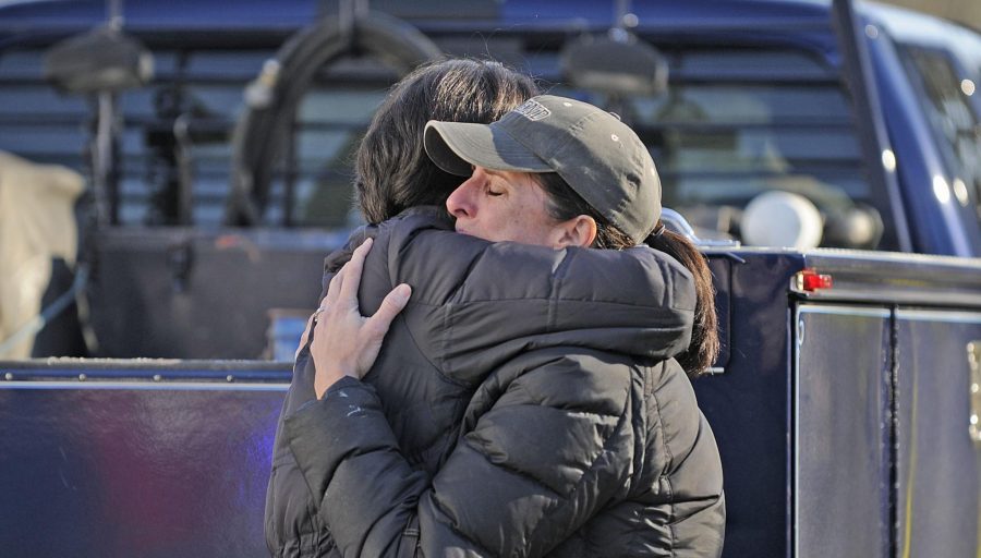 People embrace outside Sandy Hook Elementary School in Newtown, Connecticut, Friday, December 14, 2012. Twenty-seven people, including 18 children, have been killed in a shooting at Sandy Hook Elementary School in Newtown, Connecticut. (John Woike/Hartford Courant/MCT)