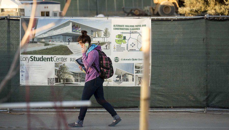 Undeclared Freshman Sarah Longi talks on the phone as she walks past the construction area for the Lory Student Center Sunday evening. Due to the construction, the MAC gym in the Recreation Center will be closed from February to Fall 2014 to accommodate the relocation of administrative offices.