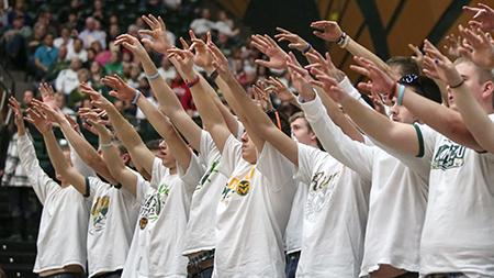 Students raise their hands during a CSU free throw at Saturday nights game in Moby Arena. Students can now pick up tickets up to three days prior to games or print them at home.