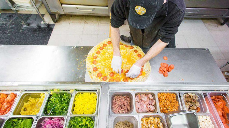 Pizza maker J Rock quickly prepares a large pie with evenly spaced pepporoni Wednesday evening at Pizza Casbah on Laurel St. Casbah is one of the many pizza resturaunts that will be participating in The Great Colorado Pie Fight tomorrow.