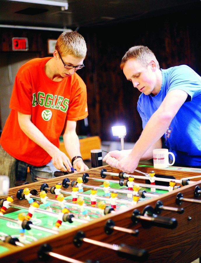 Mechanical Engineering students Darryl Beemer, left, and Kevin Westhoff, right, make adjustments to their Mechatronics final project, a foosball table with a capacitive grid that automatically moves the goalie, Friday afternoon. The College of Engineering has grown by 25% over the last decade, which is the largest growth of any college at CSU.