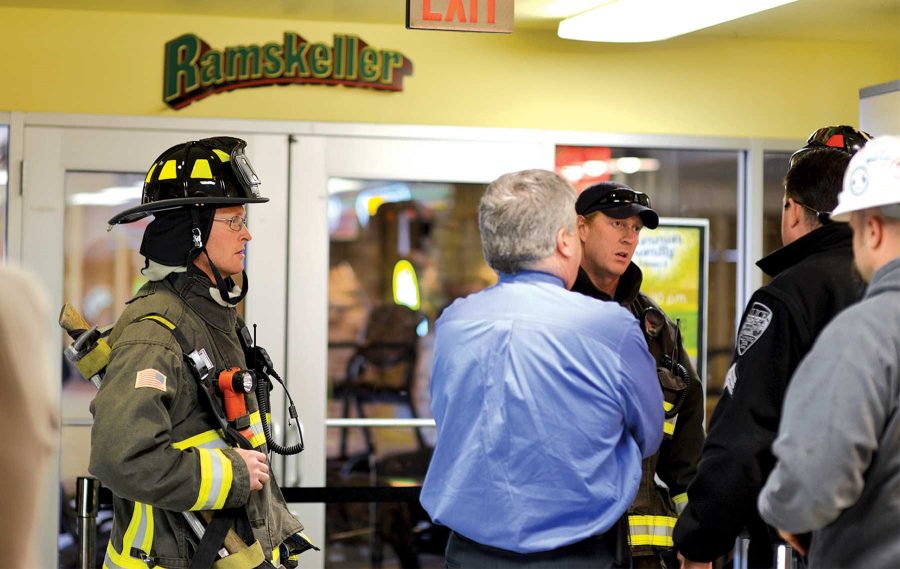 Fort Collins authorities discuss the burst pipe in the Ramskeller with LSC Executive Director Mike Ellis Wednesday at around 2:00pm. The burst pipe caused an imediate evacuation of the whole Lory Student Center.