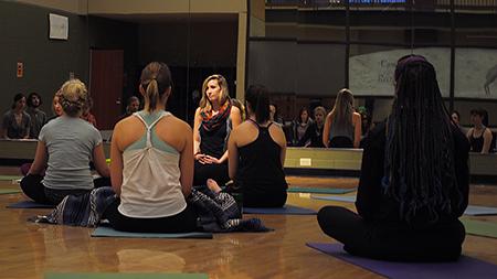 Yoga instructors Chelsea Call (left) and Sammi Imnan (right) instruct a class in one of the many studios in the REC center Thursday afternoon. There are many classes students and members can take each day.