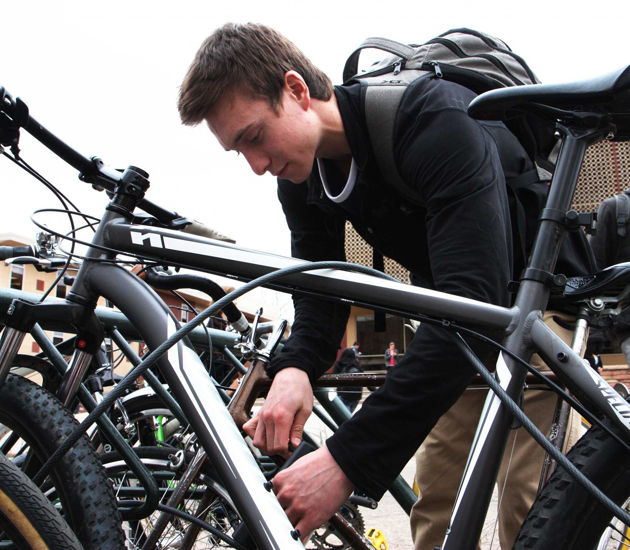 Freshman buisness major, Aaron Avery, locks up his bike outside of Clark A. Avery never leaves his bike at bike rack unlocked in fear of the common occurance of bike theft on the CSU campus.