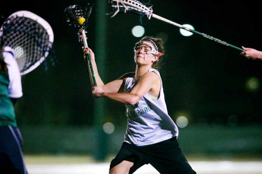 Senior Capitan of the Womens Lacrosse team, Maddie Garcia, shoots for the goal Tuesday night during practice on the football practice field. The team is playing in a tournament this weekend in Colorado Springs.