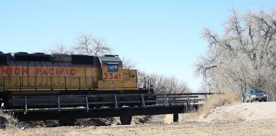 A train barrels through Fort Collins along College Avenue around noon on Thursday. There is a debate in Fort Collins whether or not to restrict trains from blowing their horns through the middle of town. (Collegian File Photo)