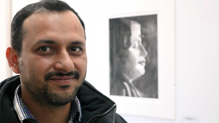 Mathematics PhD candidate Nand Sharma stands in front of his watercolor exhibit entitled Upasana (Devotion) in the new library gallery space outside of the Morgans Grind last Thursday. The entire collection is inspired by music, even the portraits or abstract pieces were created to represent various shades of music