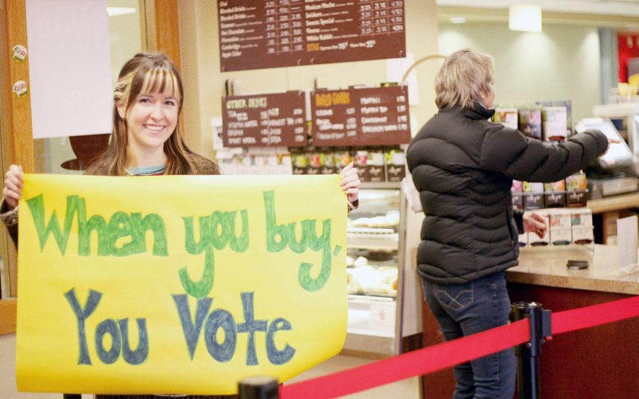 President of the Fair Trade University, Lindsey Earl, holds up one of the protest slogans "When you buy, you vote" in Sweet Sinsations, who sell fair and ethically traded coffee. Earl and her student organization believe that our buying power as consumers has political power that can change unethical business practices.