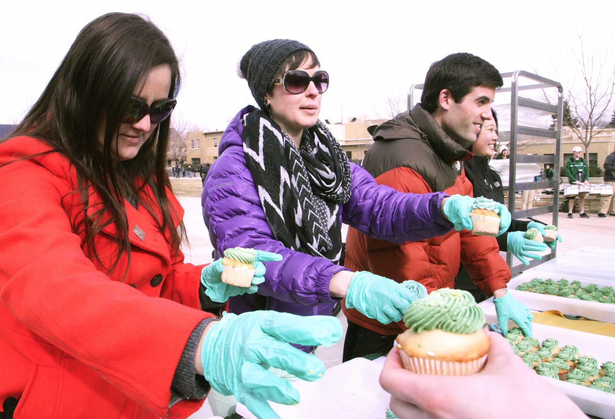 Ashley Silva and fellow CSU event staff members pass out cupcakes to hungry Rams passing through the LSC Plaza Monday afternoon. In addition to free cupcakes, CSU celebrated its birthday with a preformance by the CSU marching band and a birthday card signing open to all students who wished to sign.