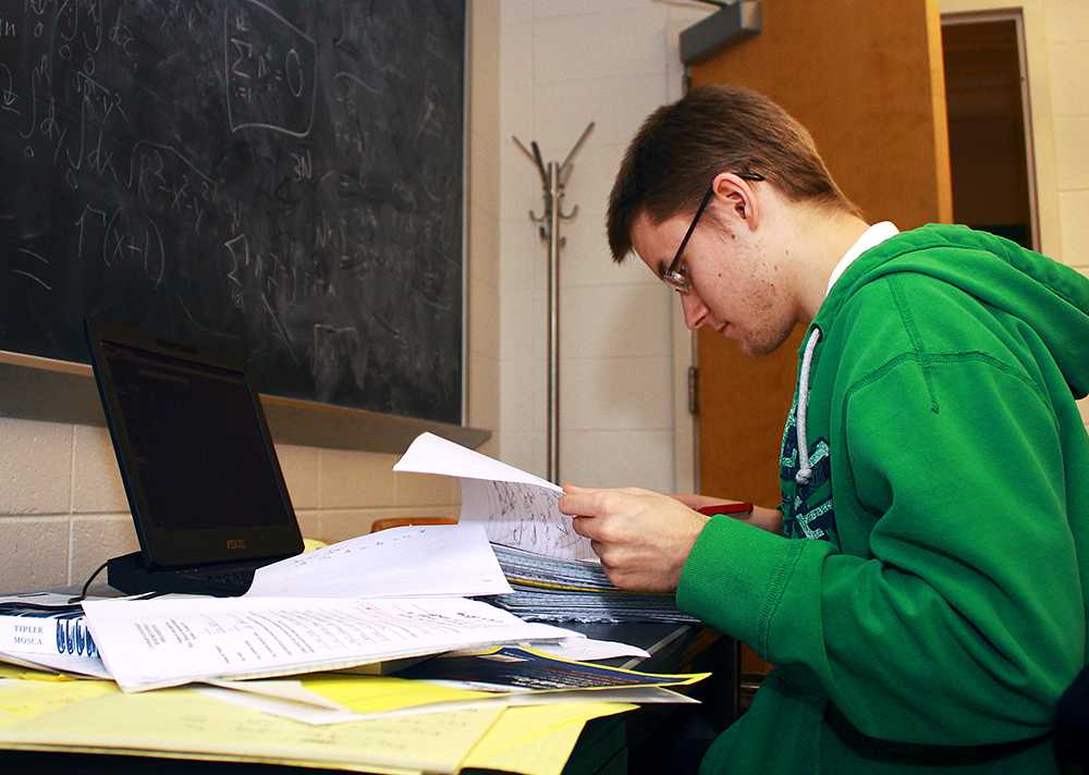 Second year graduate student and TA, Dan Pearson, grades papers for a physics course. Much of the grading and research is done by the graduate students at CSU.