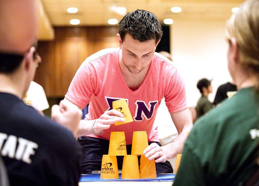 Senior business major, Cameron Delphia, represents Sigma Nu in a cup stacking event in honor of Chris Engel, a Kappa Sigma member who passed away last year. The proceeds made at the event are being donated to the Chris Engel Scholarship Fund.
