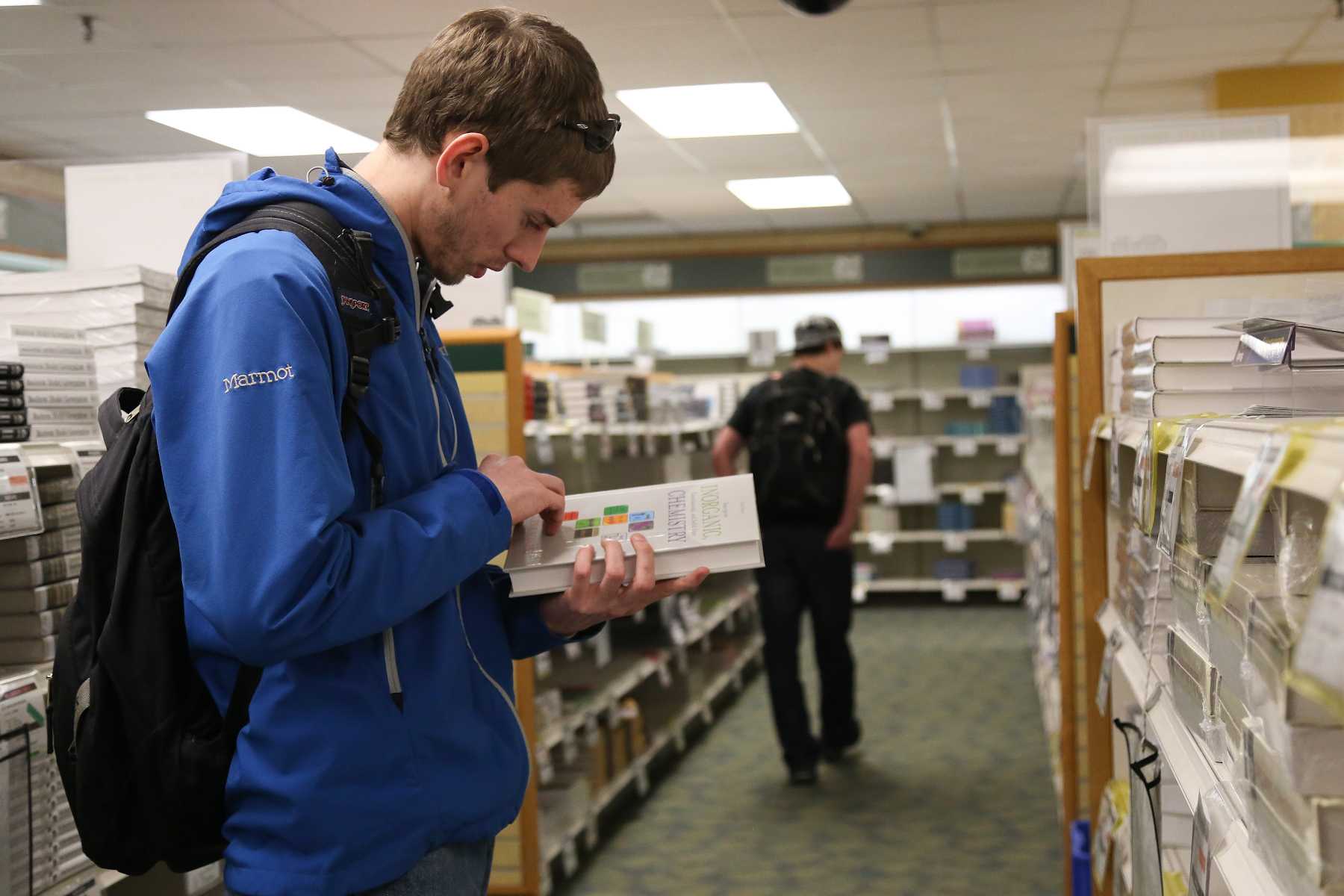 Junior Biology major Miles Eckley shops for books at the Lory Student Center bookstore Monday. With the rising cost of tuition and being a student in general, the university is working on a bill that will establish a tax holiday for all Colorado State university bookstores.