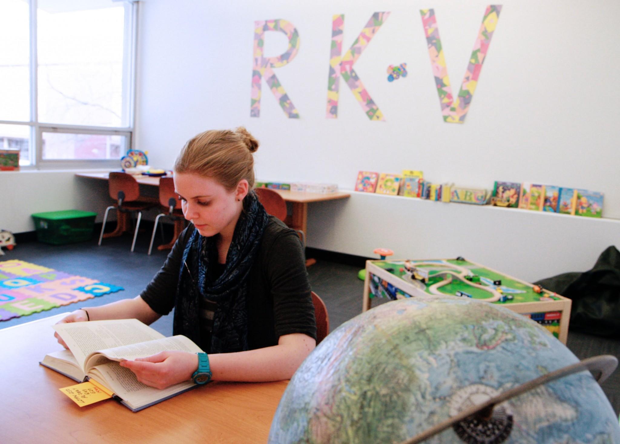 Rams Kids Village Activity Assistant, Bethany Hettinger, reads a library book as she waits for CSU student parents to drop their kids off. Started last semester, Rams Kids Village has seen an enrollment increase of eight families so far this spring and expects to see more.