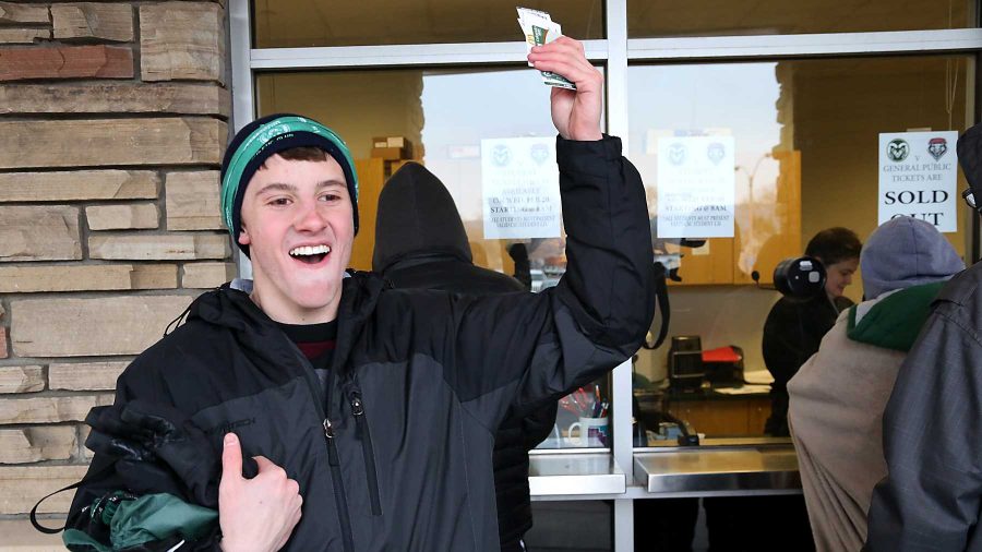 Freshman health and excersises major Jamey Cohen celebrates after waiting through the cold to get tickets for Saturday's game outside of Moby Arena Wednesday morning. Students began lining up as early as Tuesday night to be one of the first to grab their free ticket to Saturday's home matchup against New Mexico.