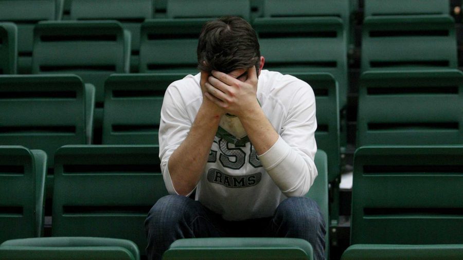 Junior business major Scott hall sits in defeat after the CSU men's basketball home loss against New Mexico Saturday in Moby. Hall got in line at 7:30 a.m. Wednesday in order to get tickets for the game.