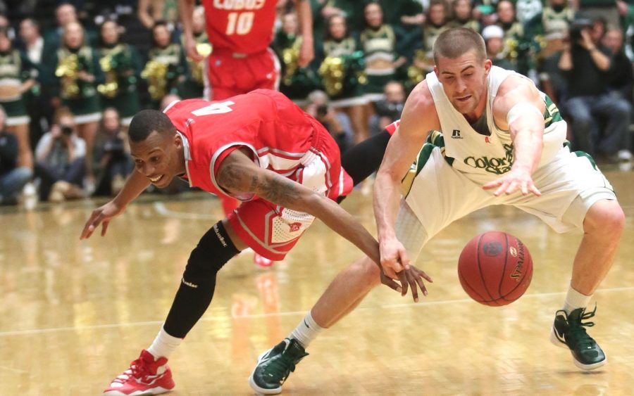 Pierce Hornung, right, leaps for the ball in the first half of the basketball game against New Mexico on Saturday in Moby Arena. The Rams lost to the Lobos 91-82.