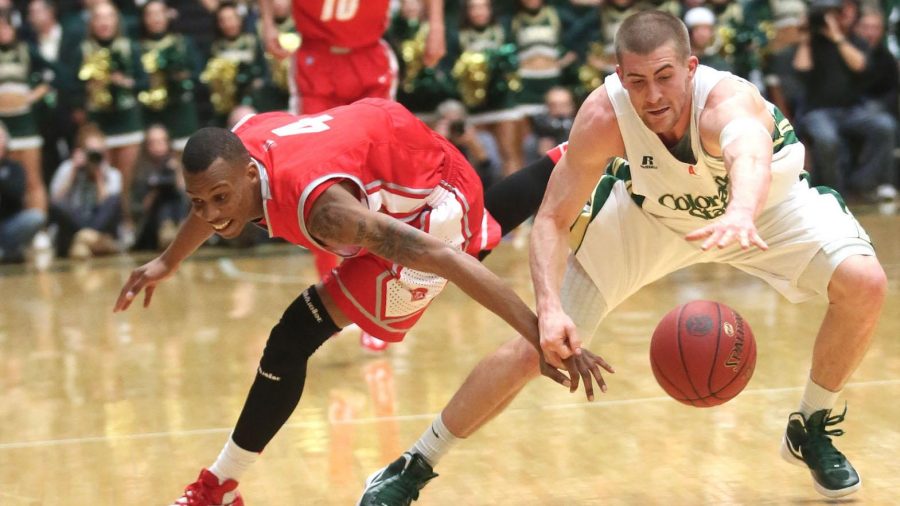 Pierce Hornung, right, leaps for the ball in the first half of the basketball game against New Mexico on Saturday in Moby Arena. The Rams lost to the Lobos 91-82.