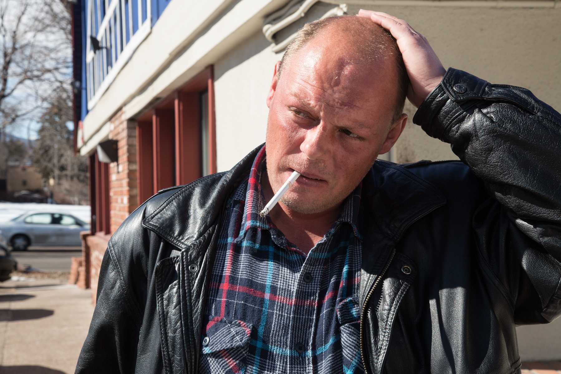 Fort Collins resident Todd Smith smokes a cigarette ouside of IHOP on College Ave. Wednesday. Smith has been a regualr to IHOP for the past 10 years, spending his days of sipping coffee and reading.