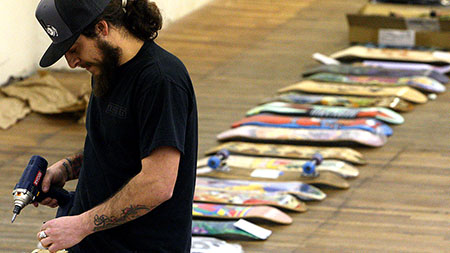Jason Binky Morgan works on setting up the displays for this Weekends All Hands on Deck fundraiser art show. The show is run by the non-profit organization called Launch-community for skateboarding.