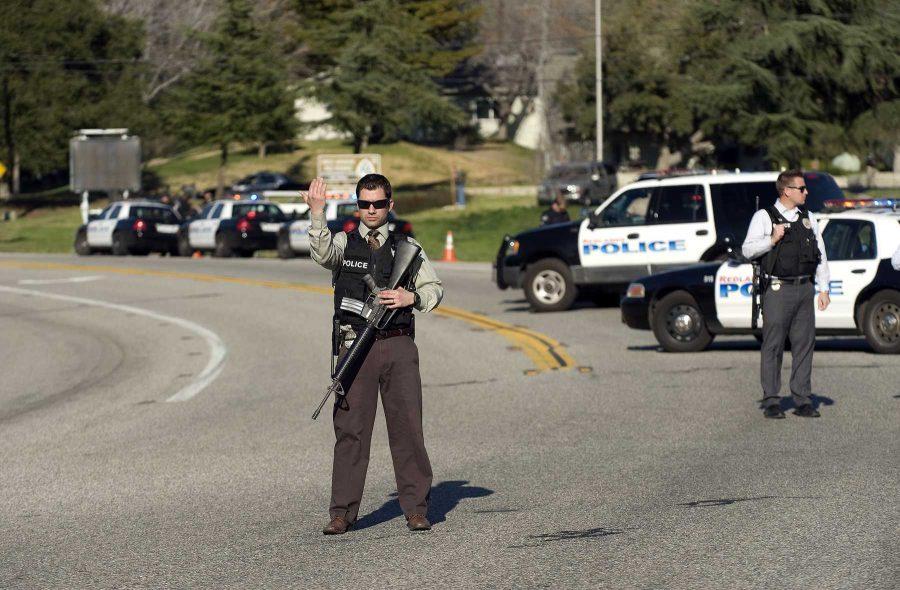Officers block Highway 38 leading to Big Bear near where shooting suspect Christopher Dorner is reported to be hiding in a cabin. (Credit Image: © Eugene Garcia/The Orange County Register/ZUMA24.com)