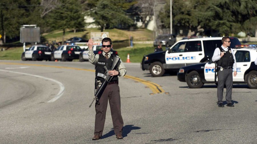 Officers block Highway 38 leading to Big Bear near where shooting suspect Christopher Dorner is reported to be hiding in a cabin. (Credit Image: © Eugene Garcia/The Orange County Register/ZUMA24.com)