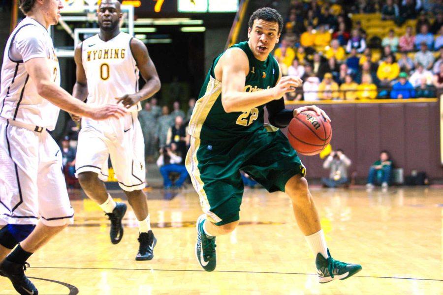 Dorian Green, 22, goes against Riley Grabau, 02, in Arena Auditorium at the University of Wyoming on Wednesday night. Dorian came out of the game with 18 points.